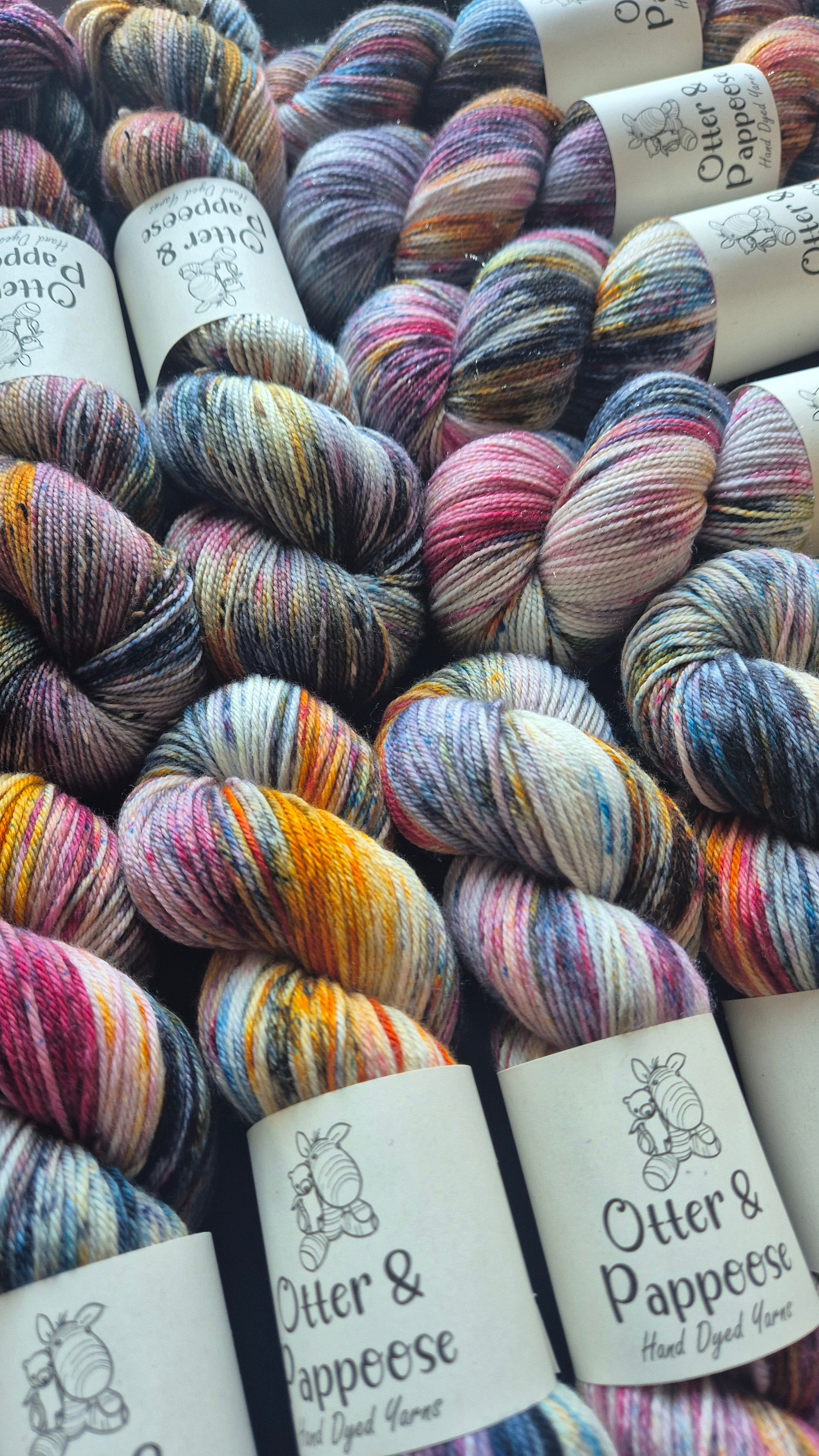 Dirty Rascal Hand Dyed variegated yarn by Otter and Pappoose Yarn with a mix of strong colours, yellow, orange, red, black and blue on Sparkle, DK, 4ply bases.